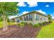 Landscaped backyard featuring lush greenery, a well-maintained lawn, and an inviting patio area at 10597 Sw 90Th Street Rd, Ocala, FL 34481