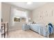Cozy bedroom featuring neutral walls, carpeted floor and a large window at 10597 Sw 90Th Street Rd, Ocala, FL 34481