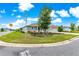 Well-maintained corner lot showcasing a beautiful lawn, mature landscaping, and a charming home exterior at 10597 Sw 90Th Street Rd, Ocala, FL 34481