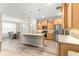 Spacious kitchen with stainless steel appliances, large island, and pendant lighting, open to the dining area at 10597 Sw 90Th Street Rd, Ocala, FL 34481