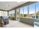 Enclosed lanai with ample windows, offering serene views of the surrounding neighborhood and landscaping at 10597 Sw 90Th Street Rd, Ocala, FL 34481
