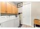 Functional laundry room featuring upper cabinets, washer, dryer, and ample storage space at 10597 Sw 90Th Street Rd, Ocala, FL 34481