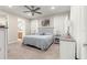 Light and airy main bedroom featuring an ensuite bathroom, ceiling fan, and neutral decor at 10597 Sw 90Th Street Rd, Ocala, FL 34481