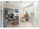 Cozy home office with neutral walls, comfortable seating, and ample natural light through sheer curtains at 10597 Sw 90Th Street Rd, Ocala, FL 34481
