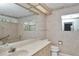 Bathroom with a large mirror, cabinets, and neutral wallpaper at 10819 Sw 84Th Ter, Ocala, FL 34481