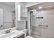 Bathroom featuring a sink, cabinets, modern tile shower, and a glass wall at 10819 Sw 84Th Ter, Ocala, FL 34481