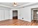 Bedroom with wood floors, a ceiling fan, and an ensuite bathroom at 10819 Sw 84Th Ter, Ocala, FL 34481