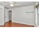 This bedroom features a ceiling fan, wood floors and a window for natural light at 10819 Sw 84Th Ter, Ocala, FL 34481