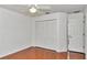 Bright bedroom featuring a ceiling fan, wood floors and a closet for ample storage at 10819 Sw 84Th Ter, Ocala, FL 34481