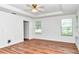 Bedroom featuring wood floors, a ceiling fan, and two windows for ample natural light at 10819 Sw 84Th Ter, Ocala, FL 34481