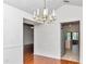 Elegant dining area with a chandelier, hardwood floors, and a view of the kitchen at 10819 Sw 84Th Ter, Ocala, FL 34481
