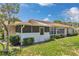 Charming home exterior features a screened lanai and bright sunroom surrounded by lush landscaping at 10819 Sw 84Th Ter, Ocala, FL 34481