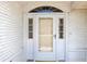 Close-up of the front door featuring glass sidelights and transom window on a brick facade at 10819 Sw 84Th Ter, Ocala, FL 34481