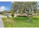 Well-maintained home with a spacious front yard, mature trees, and colorful flowerbeds for curb appeal at 10819 Sw 84Th Ter, Ocala, FL 34481