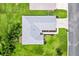 Aerial view of the home showcasing the roof, driveway, and surrounding greenery at 12178 Se 174Th Pl, Summerfield, FL 34491