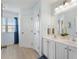 Bathroom with double sink vanity, bright lighting, and a separate room for the toilet at 12178 Se 174Th Pl, Summerfield, FL 34491