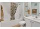 Bathroom with a shower-tub combo and a white vanity at 12178 Se 174Th Pl, Summerfield, FL 34491