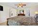 Spacious bedroom featuring dark wood furniture, a ceiling fan, and wood-look floors at 12178 Se 174Th Pl, Summerfield, FL 34491