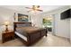 Bedroom featuring a ceiling fan, sliding glass door, and a large, comfortable bed at 12178 Se 174Th Pl, Summerfield, FL 34491