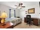 Bedroom featuring a ceiling fan, closet, and a wooden desk at 12178 Se 174Th Pl, Summerfield, FL 34491