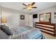 Bedroom featuring a ceiling fan, closet, and an elegantly-designed dresser at 12178 Se 174Th Pl, Summerfield, FL 34491