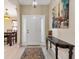 Inviting foyer with a decorative rug and table, setting a warm tone at 12178 Se 174Th Pl, Summerfield, FL 34491