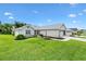 Beautiful single-story home with a well-manicured lawn and three-car garage at 12178 Se 174Th Pl, Summerfield, FL 34491