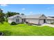 Well-maintained single Gathering home with a lush green lawn and manicured landscaping at 12178 Se 174Th Pl, Summerfield, FL 34491