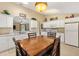 Bright kitchen features white cabinets, wood-look flooring, and stainless steel appliances at 12178 Se 174Th Pl, Summerfield, FL 34491