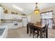 Bright and functional kitchen features white cabinets and an adjacent dining area at 12178 Se 174Th Pl, Summerfield, FL 34491