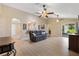 Spacious living room with vaulted ceiling, ceiling fans, slider, and light wood flooring at 12178 Se 174Th Pl, Summerfield, FL 34491