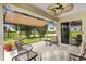 Covered patio area overlooking the manicured backyard at 12178 Se 174Th Pl, Summerfield, FL 34491