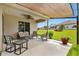 Covered patio area overlooking the manicured backyard and privacy fence at 12178 Se 174Th Pl, Summerfield, FL 34491
