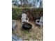 Backyard patio area with three Adirondack chairs surrounding a fire pit at 1245 Nw 73Rd Ter, Ocala, FL 34482