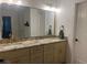Bright bathroom featuring double sink vanity with granite countertop and modern fixtures at 1245 Nw 73Rd Ter, Ocala, FL 34482