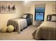 Bedroom featuring two twin beds, comfortable covers, geometric art and natural lighting at 1245 Nw 73Rd Ter, Ocala, FL 34482