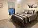 Bedroom featuring a bed, modern artwork, and a window with a lovely view at 1245 Nw 73Rd Ter, Ocala, FL 34482