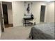 Neutral bedroom featuring a desk, chair, horse painting, and two doorways at 1245 Nw 73Rd Ter, Ocala, FL 34482