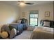 Bedroom featuring two twin beds, geometric art, and a window with a view at 1245 Nw 73Rd Ter, Ocala, FL 34482