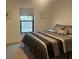 Neutral bedroom with a comfortable bed, and a view of the outdoors through a window at 1245 Nw 73Rd Ter, Ocala, FL 34482