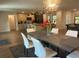 Open-concept dining and kitchen area with modern light fixtures and dining table at 1245 Nw 73Rd Ter, Ocala, FL 34482