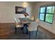 Dining room featuring a modern chandelier, table, chairs, and a large window at 1245 Nw 73Rd Ter, Ocala, FL 34482