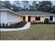 Welcoming home with a modern walkway and neatly manicured landscaping leading to the front door at 1245 Nw 73Rd Ter, Ocala, FL 34482