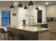 Modern kitchen with an expansive island, pendant lights, and an open layout connecting living areas at 1245 Nw 73Rd Ter, Ocala, FL 34482