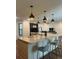 Spacious kitchen with bar stool seating, modern lighting, and seamless flow into the inviting living area at 1245 Nw 73Rd Ter, Ocala, FL 34482