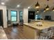 Bright and airy kitchen with an island, modern fixtures, and easy access to adjacent sitting area at 1245 Nw 73Rd Ter, Ocala, FL 34482