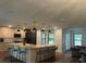 Gourmet kitchen featuring an island, ample seating, and a fluid transition to the living space at 1245 Nw 73Rd Ter, Ocala, FL 34482