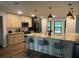 Stunning kitchen with a large island, pendant lighting, and modern appliances and lots of storage at 1245 Nw 73Rd Ter, Ocala, FL 34482