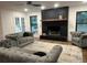 Bright living area featuring a striking brick fireplace, neutral color palette, and ample natural light at 1245 Nw 73Rd Ter, Ocala, FL 34482