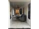 Covered patio area with comfortable seating, ceiling fan, and view of the interior at 1245 Nw 73Rd Ter, Ocala, FL 34482